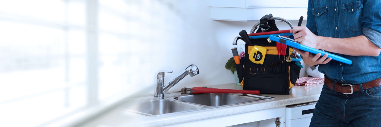 Professional plumber with tools ready to help